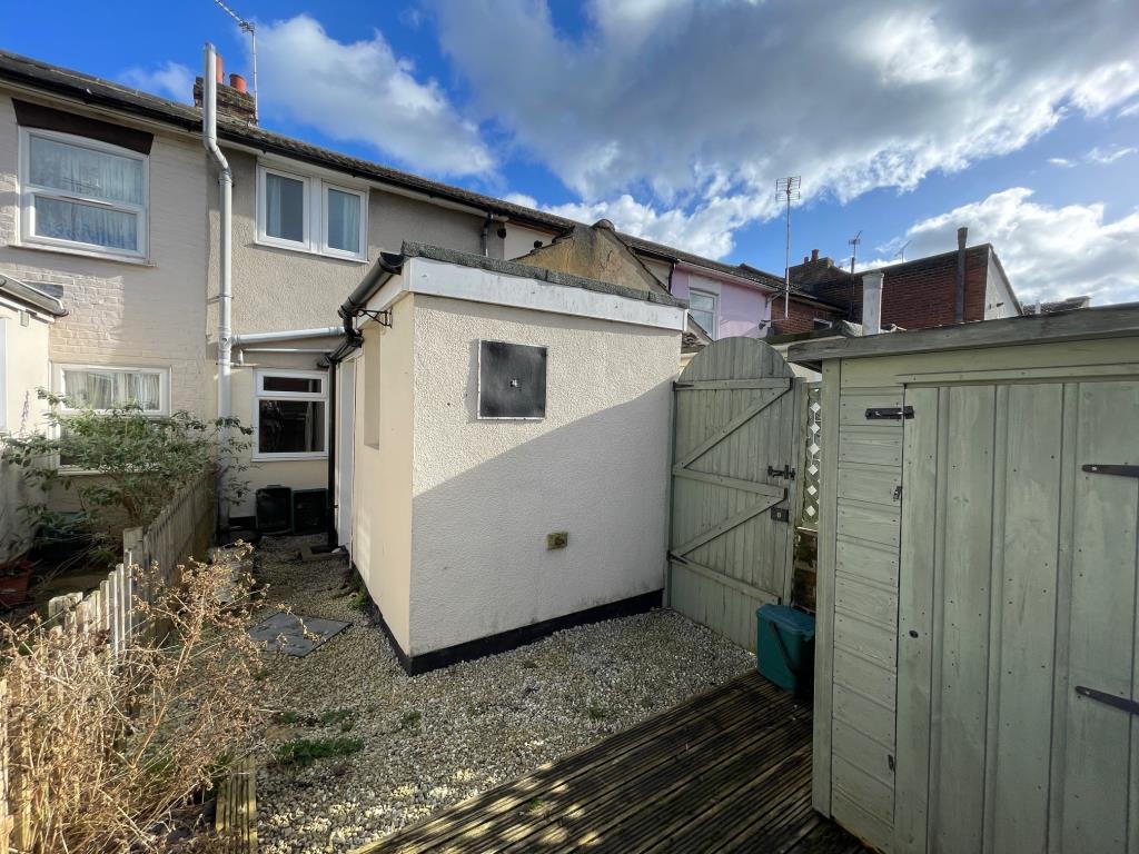 Lot: 107 - TWO-BEDROOM TERRACE HOUSE - rear of the property with gate to bin access passage